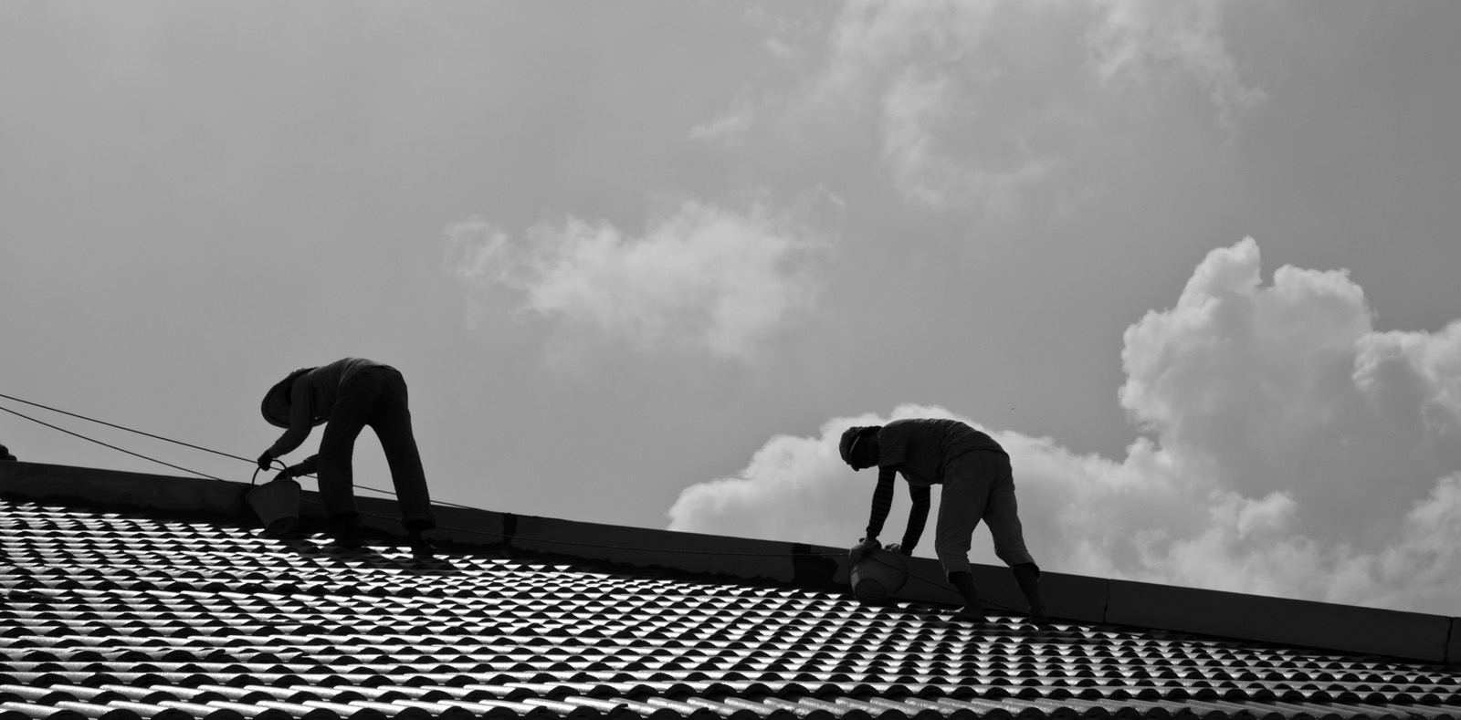 Black and white photo of roofers