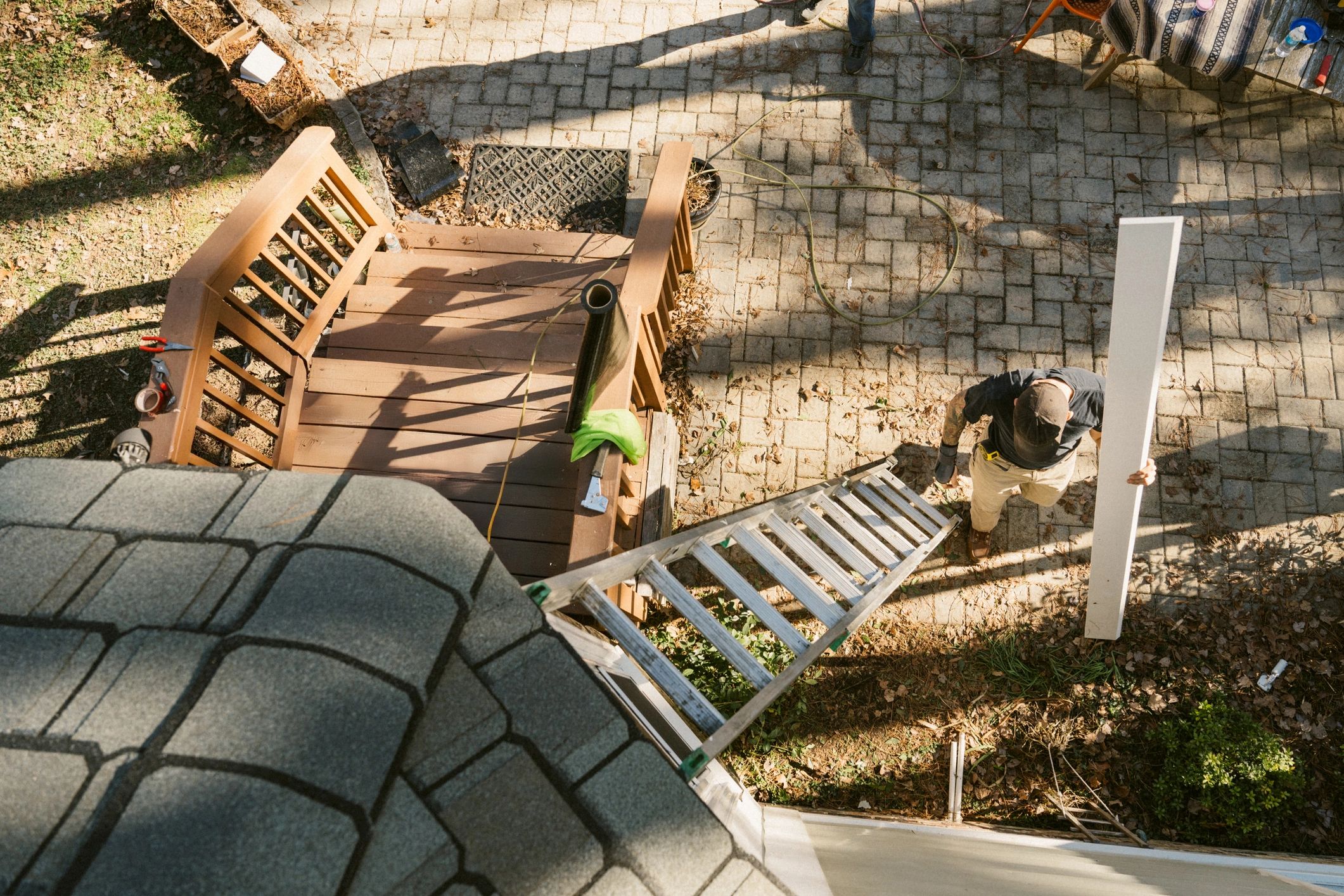 Contractors performing exterior repair work on a home