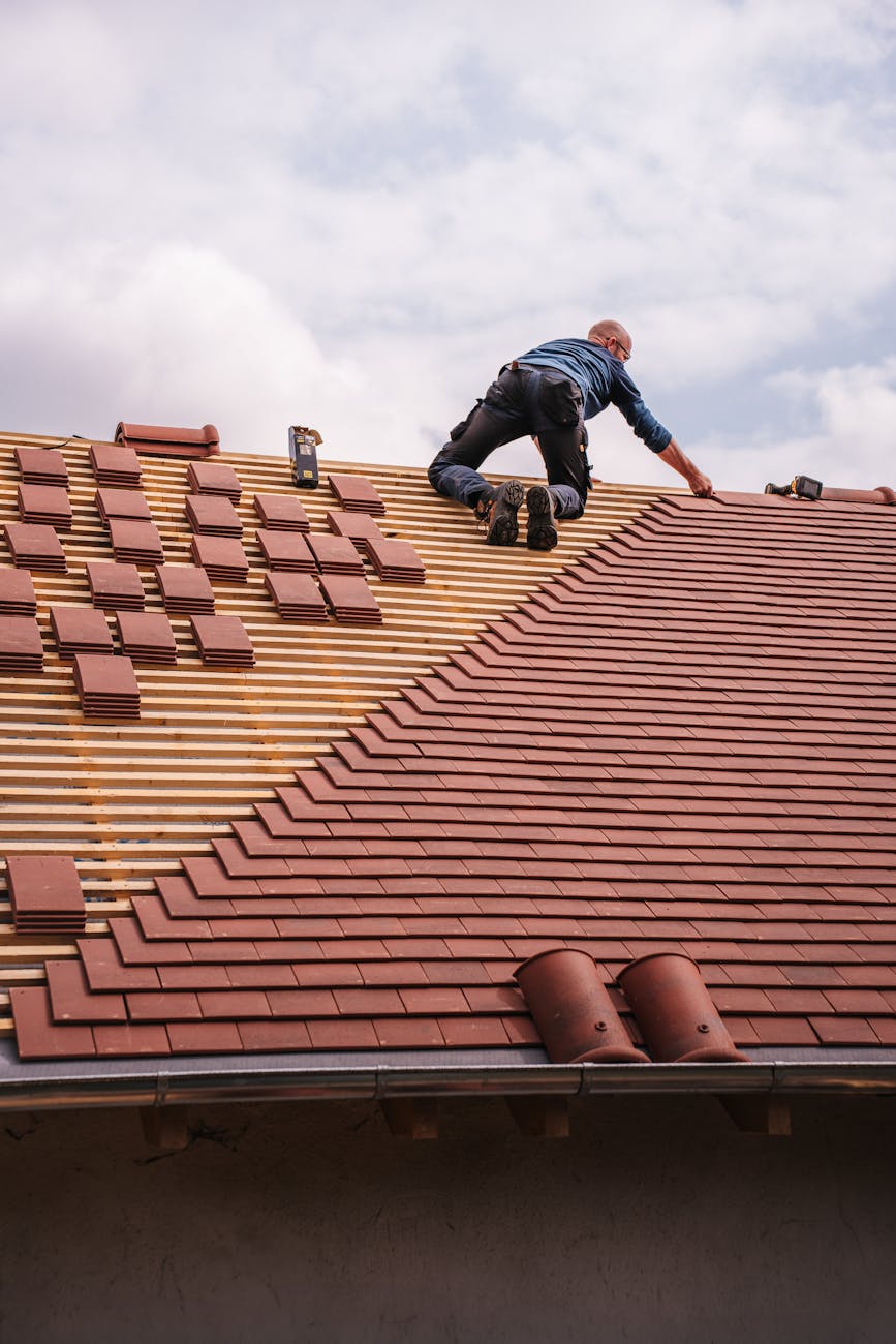 roofer working on new house roof installation